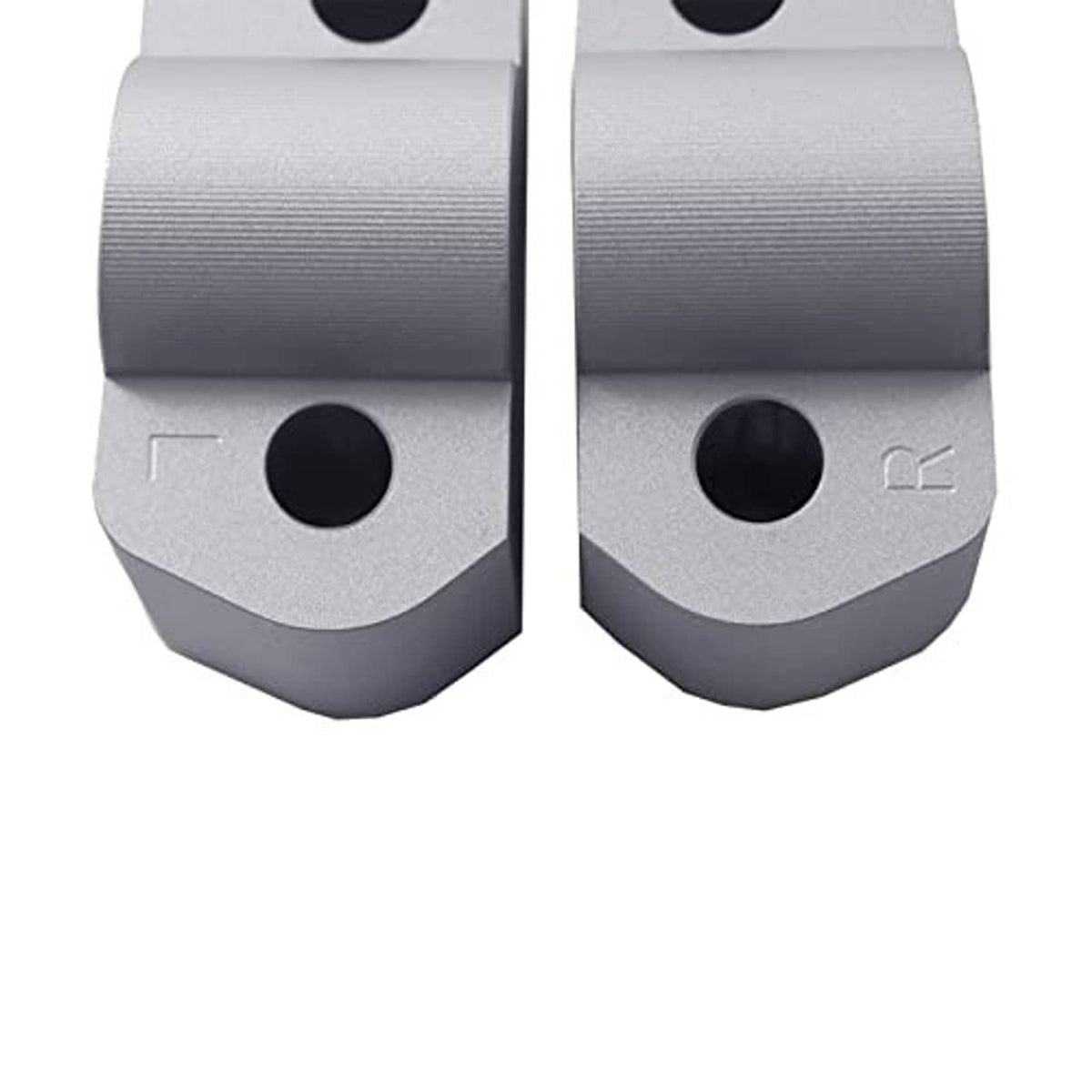Silver CNC aluminum riser bases with large circular mounting holes and engraved mark