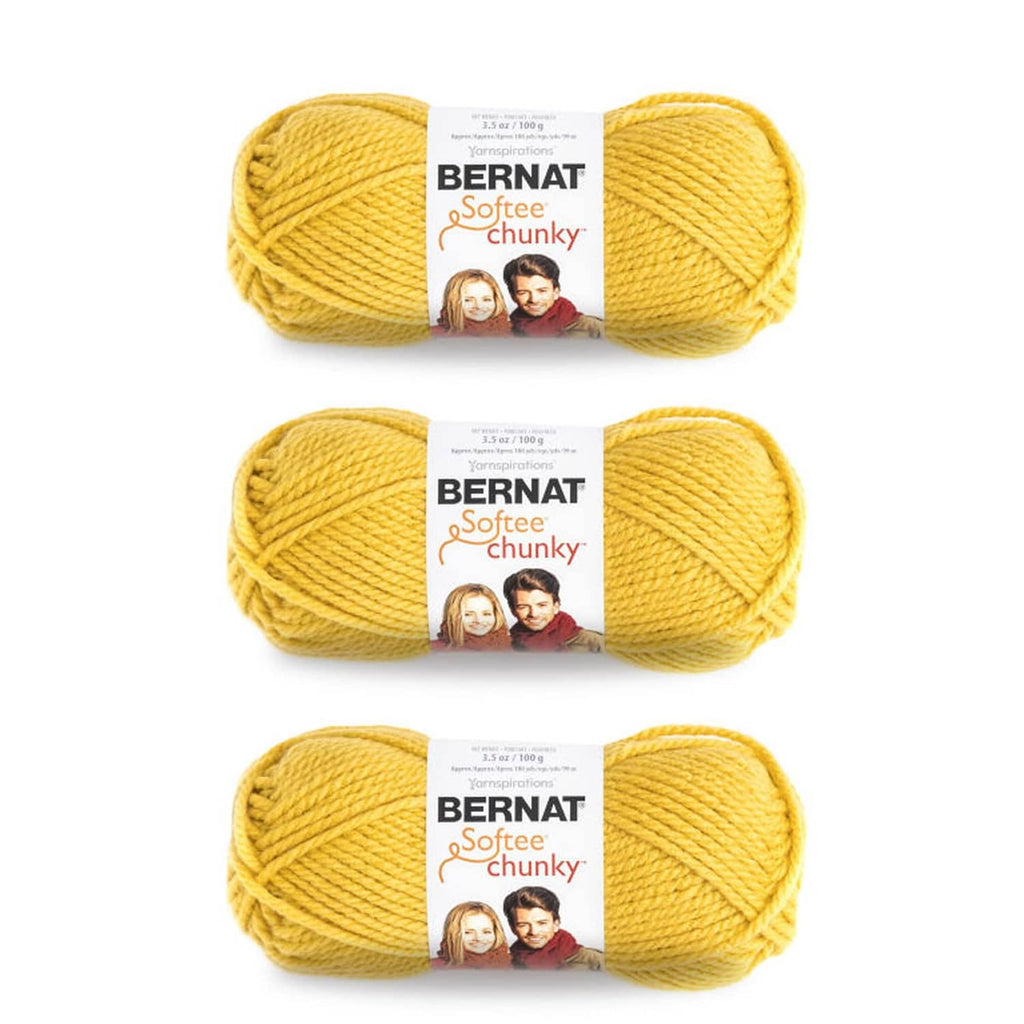 Three skeins of chunky yarn in glowing gold, stacked in a pack