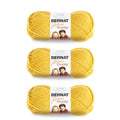 Three skeins of chunky yarn in glowing gold, stacked in a pack