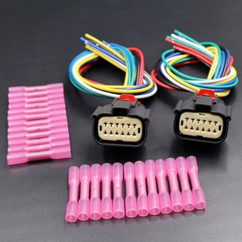 Headlight wiring connector pair with black housings, multi-color leads, and pink terminal sleeves
