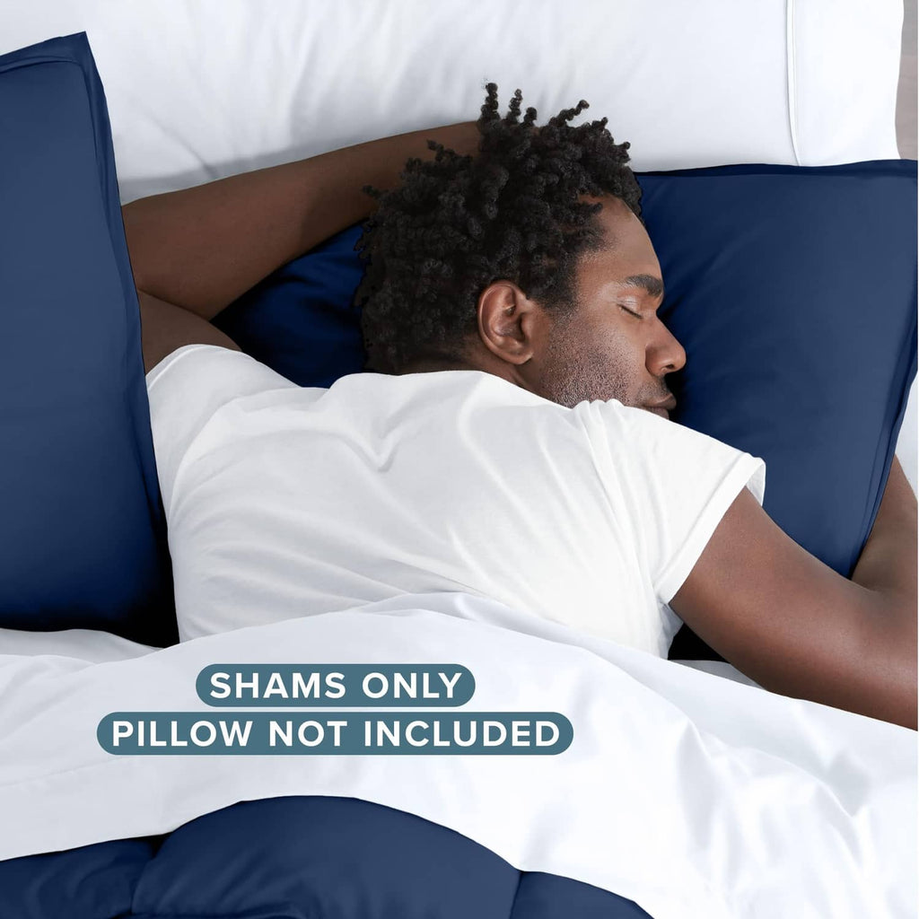 Dark blue pillow sham on bed, envelope opening visible; pillow not included