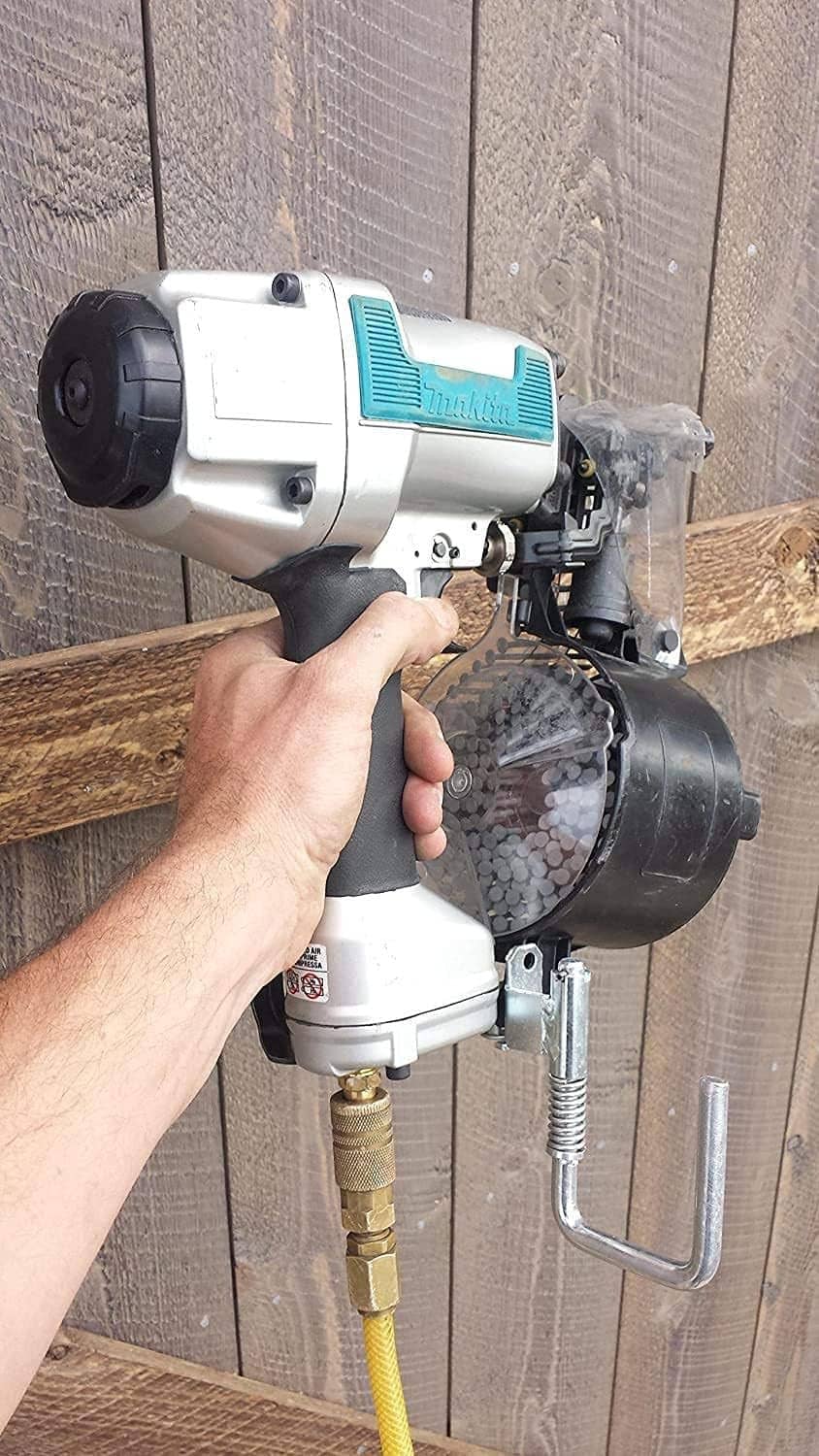 Spring retractable nail gun hanger on the tool body, with brass hook and black pad