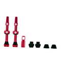 Red Presta tubeless valve set with two metal stems and black rubber bases