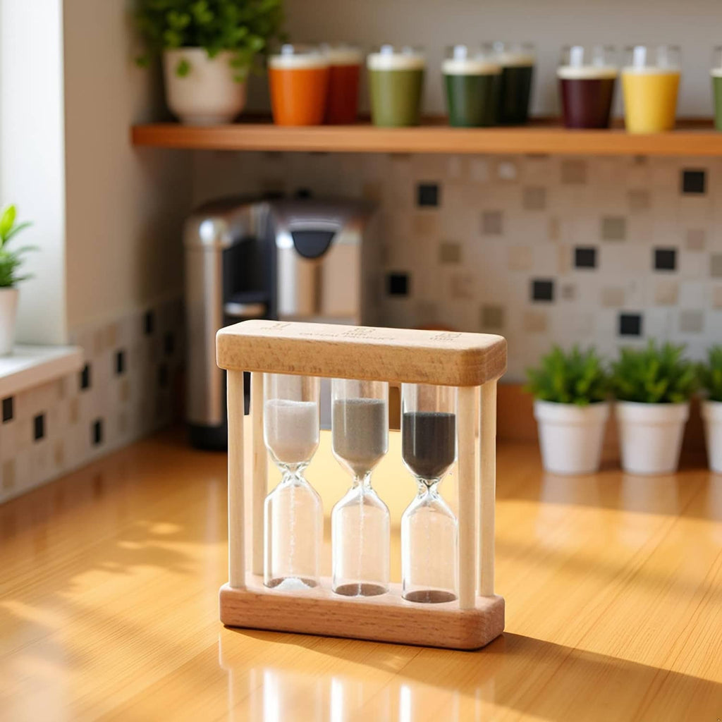 Wooden hourglass sand timer on table with three glass chambers and dark sand