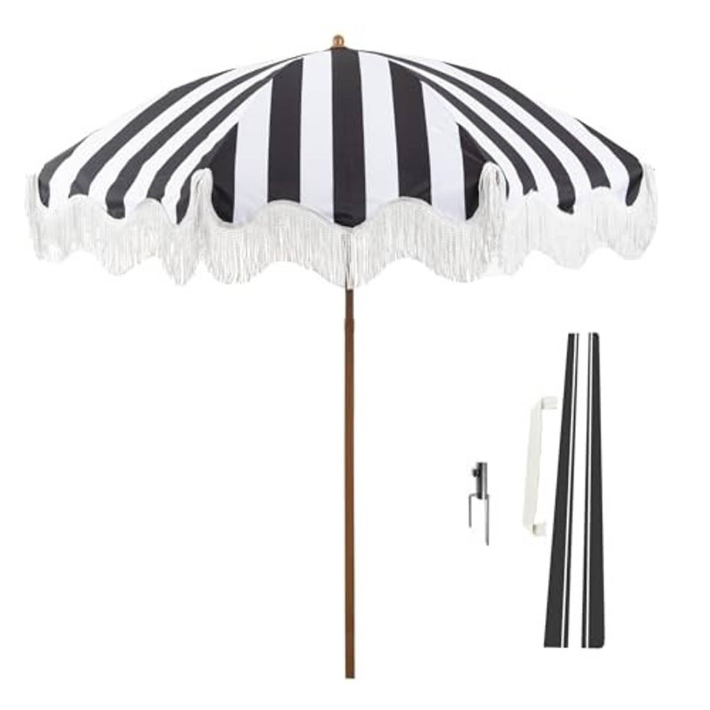 Black-and-white striped patio umbrella with white fringe edge and wooden pole