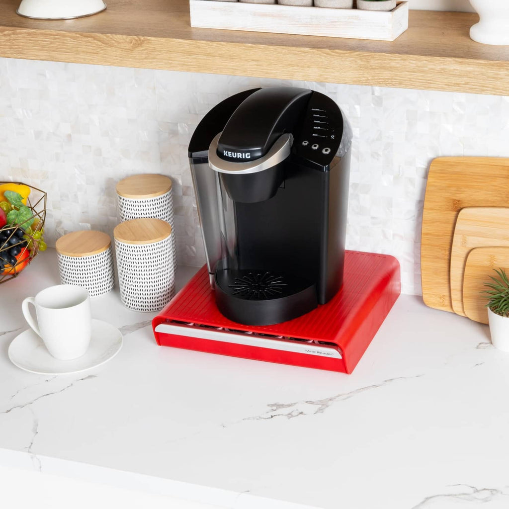 Red pod drawer with Keurig-labeled black brewer and pod slots on front tray