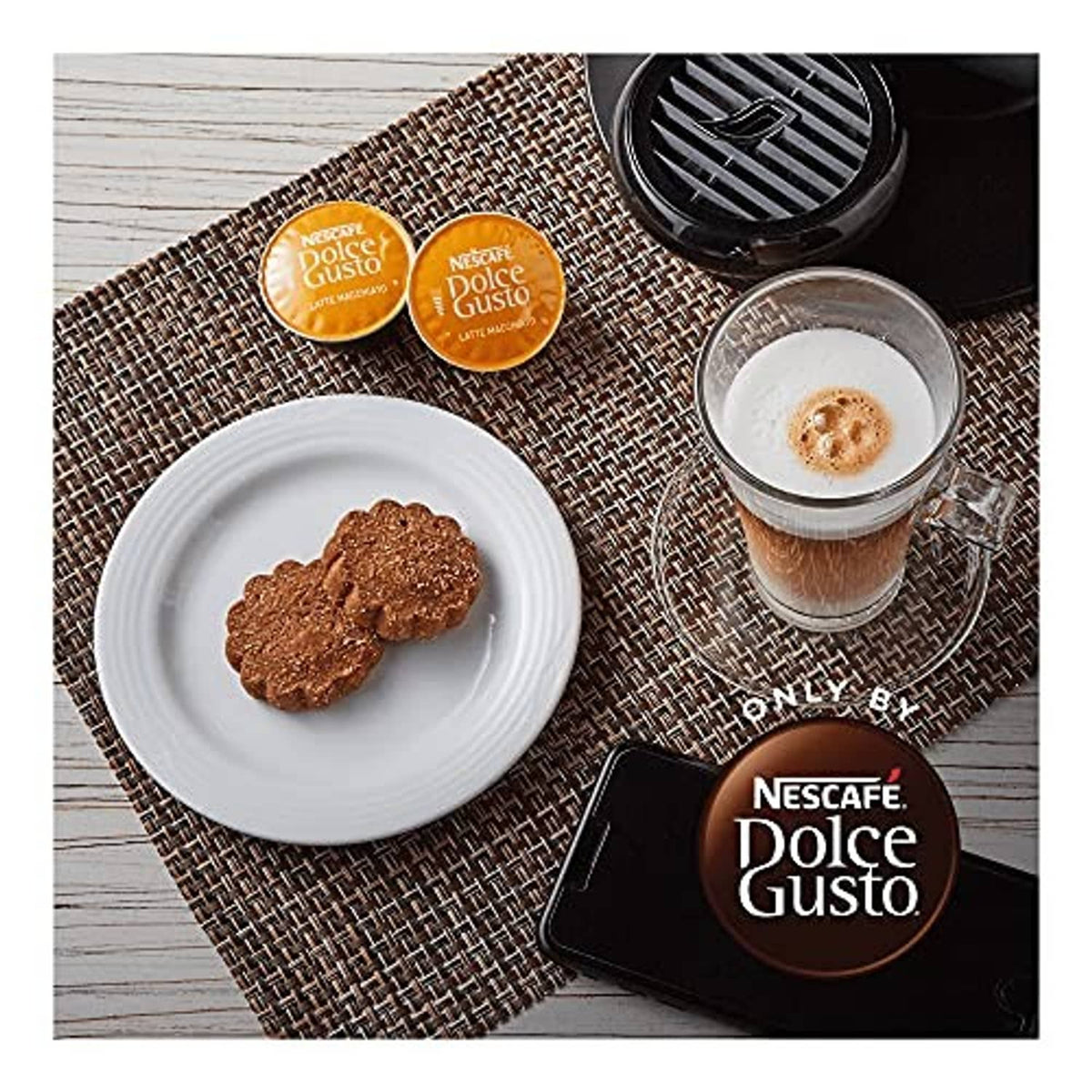 Latte macchiato coffee capsules with a glass of brewed coffee and used pod