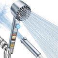 Filtered handheld shower head with blue pause button and fine spray face
