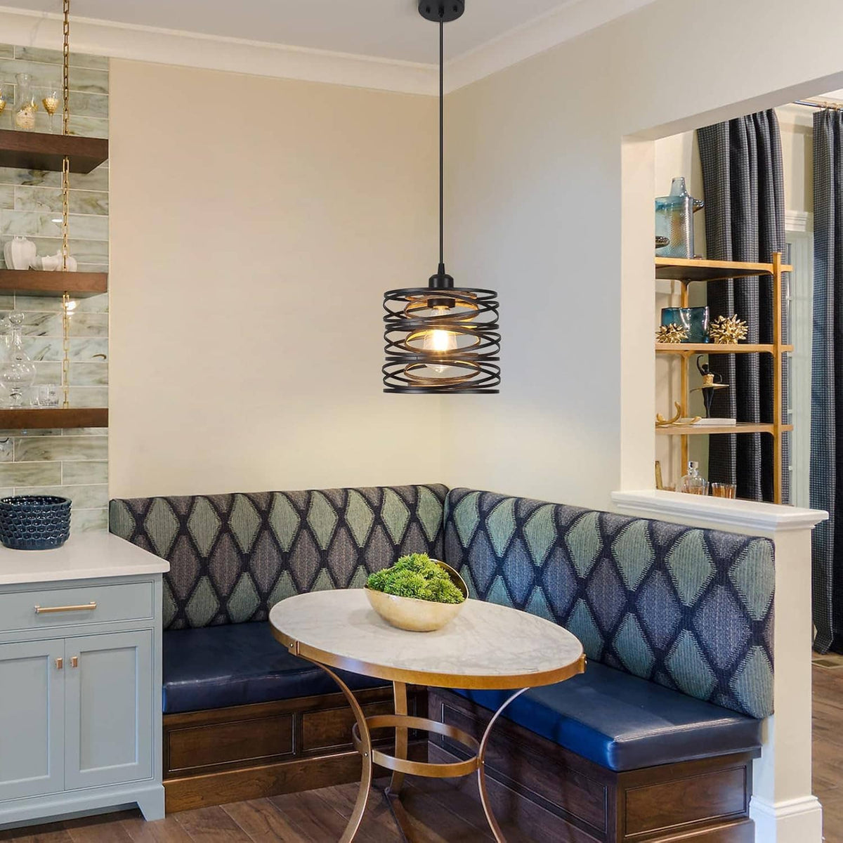 Black spiral cage pendant light suspended above a seating area