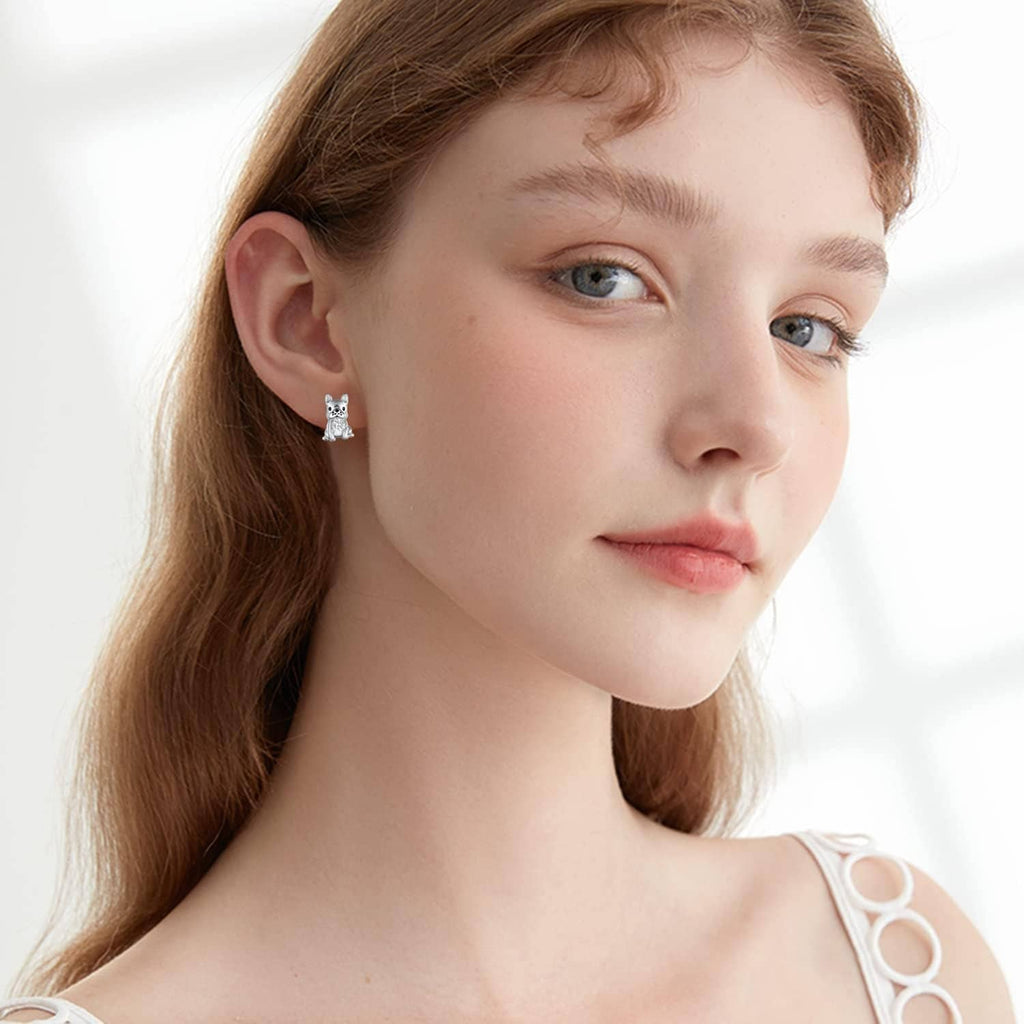 Woman wearing French bulldog stud earrings in 925 sterling silver with clear crystal