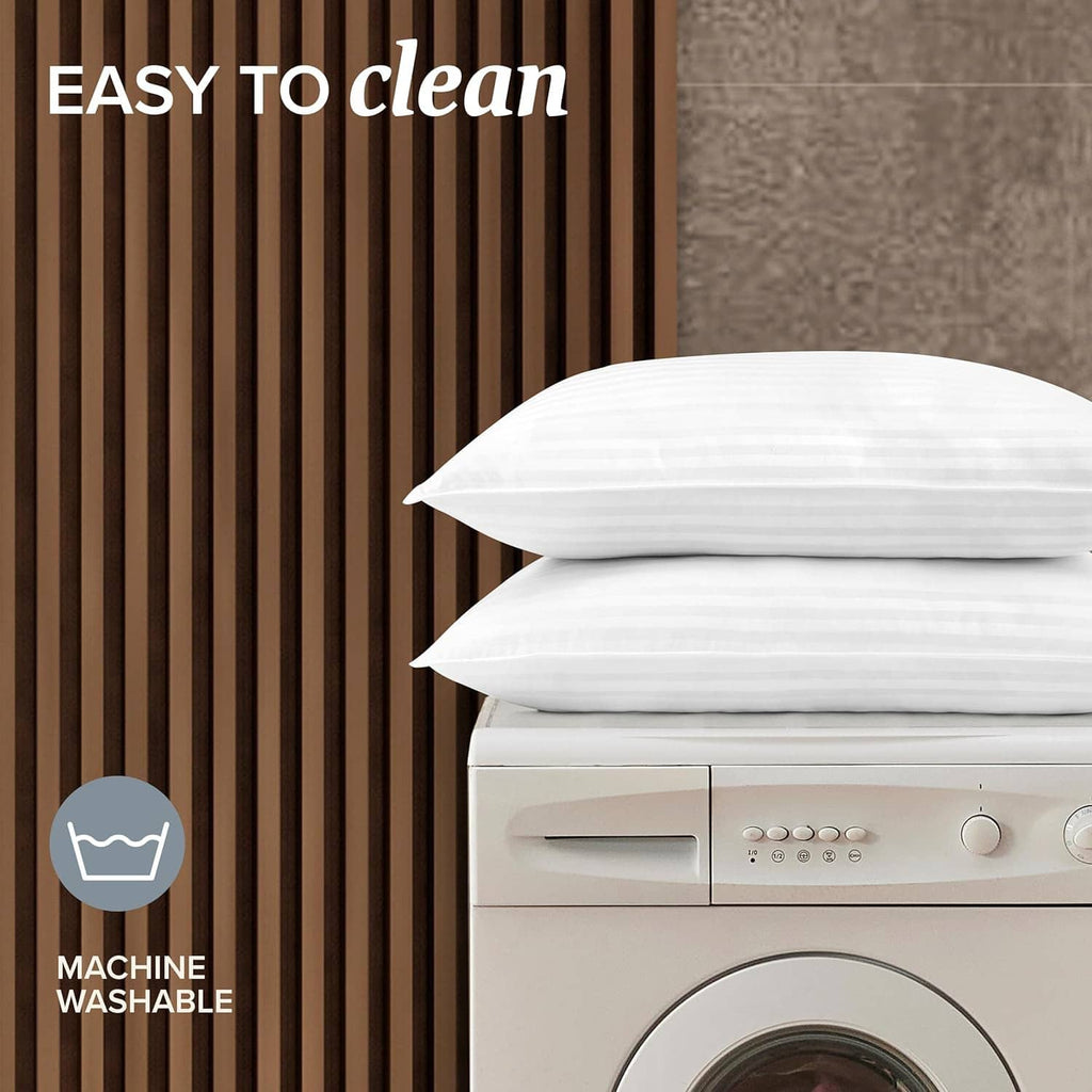 White down alternative pillows with striped covers, stacked pair for easy care