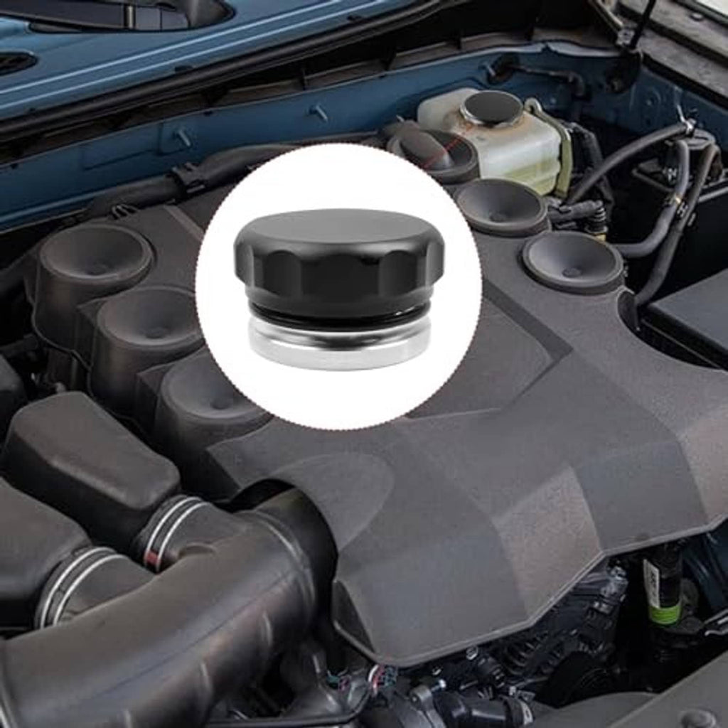 Fuel filler neck cap installed on engine area, black top with silver base