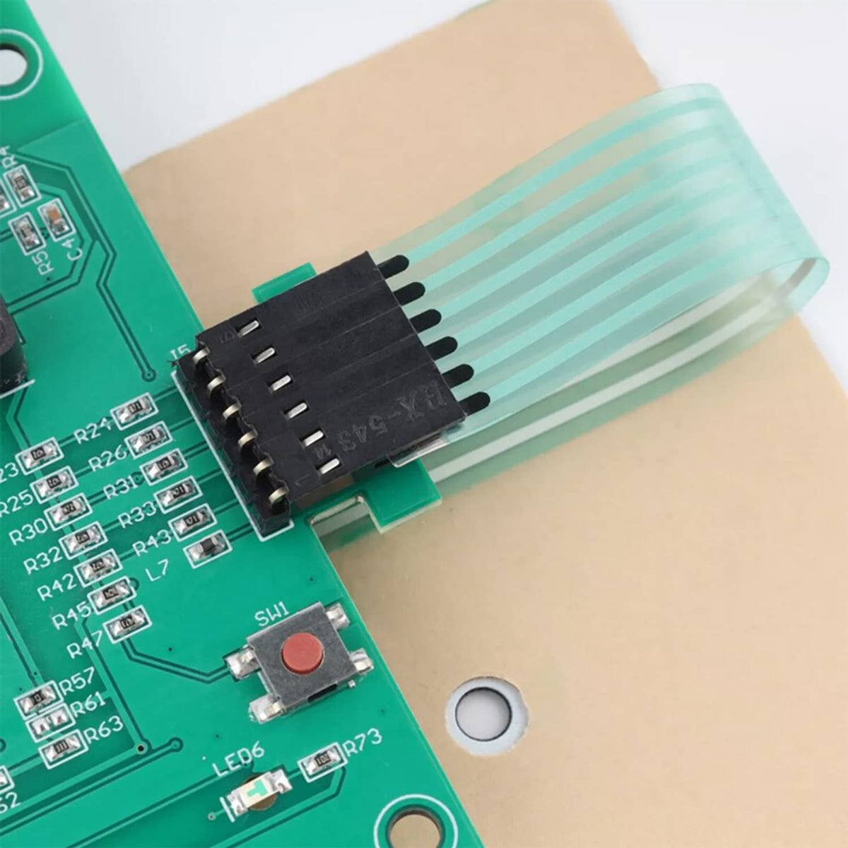 Close-up of green PCB with multi-pin connector and ribbon cable for Pentair heater