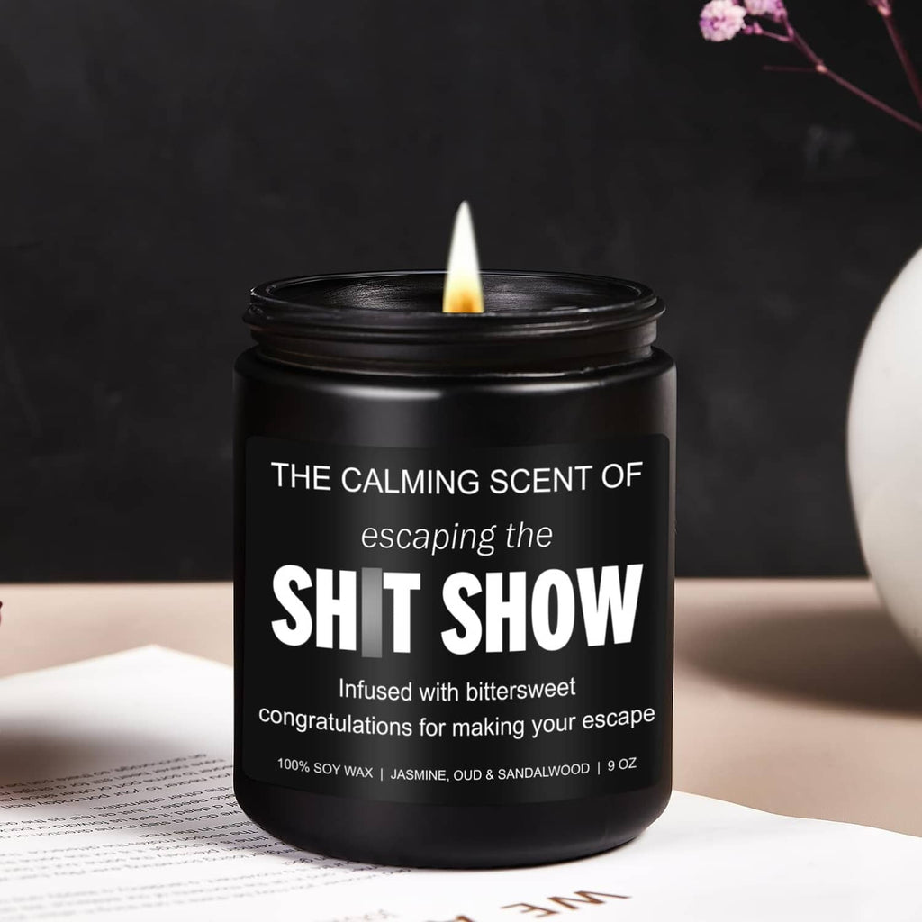 Black jar candle with lit wick and bold white label; soy wax, 9 oz.