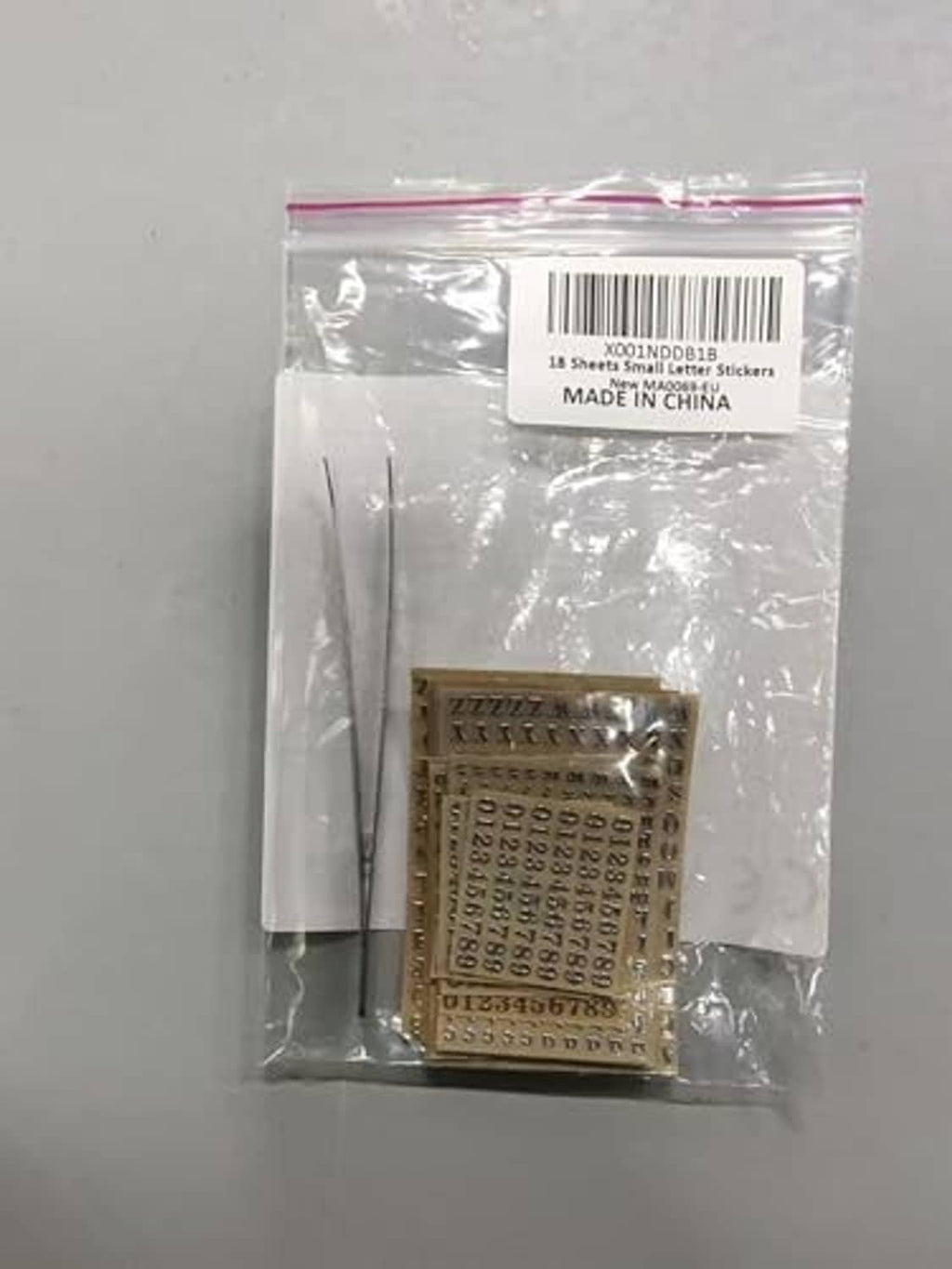 Packaged gold letter and number nail sticker sheets in sealed plastic bag