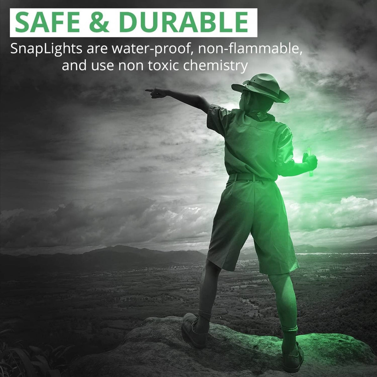 Soldier holding a green glow stick, bright translucent tube for safety