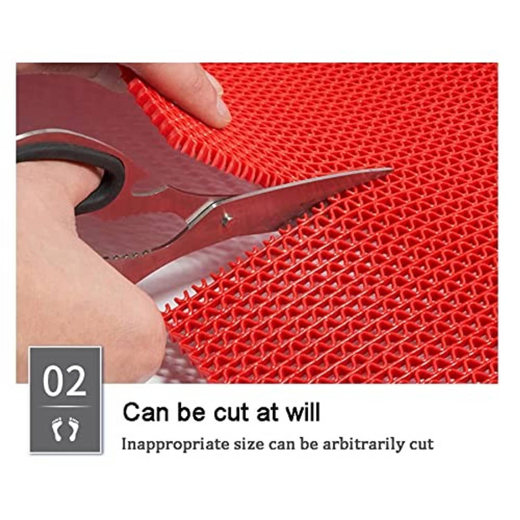 Red PVC drainage mat with mesh surface being trimmed with scissors