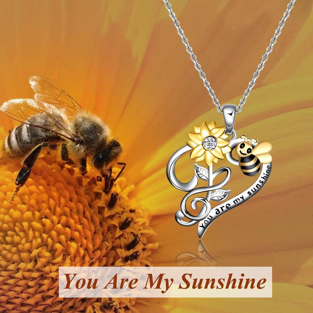 Bee-and-flower pendant necklace on silver-tone chain with sunshine text