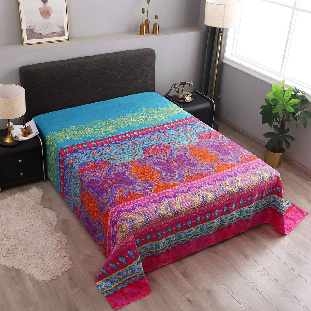 Boho paisley sheet set with vivid multicolor flat sheet draped over bed