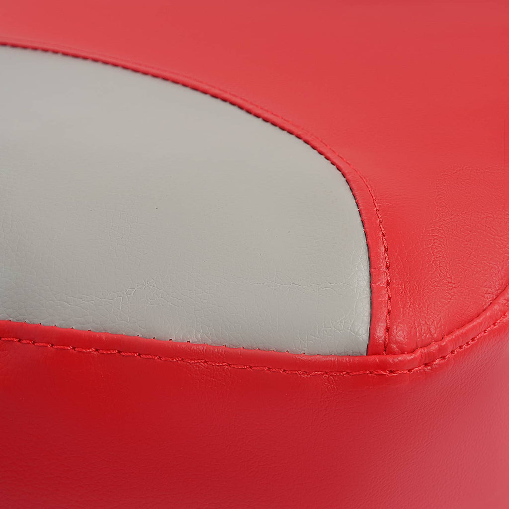 Close-up of red seat cover edge with contrasting gray panel and visible stitching