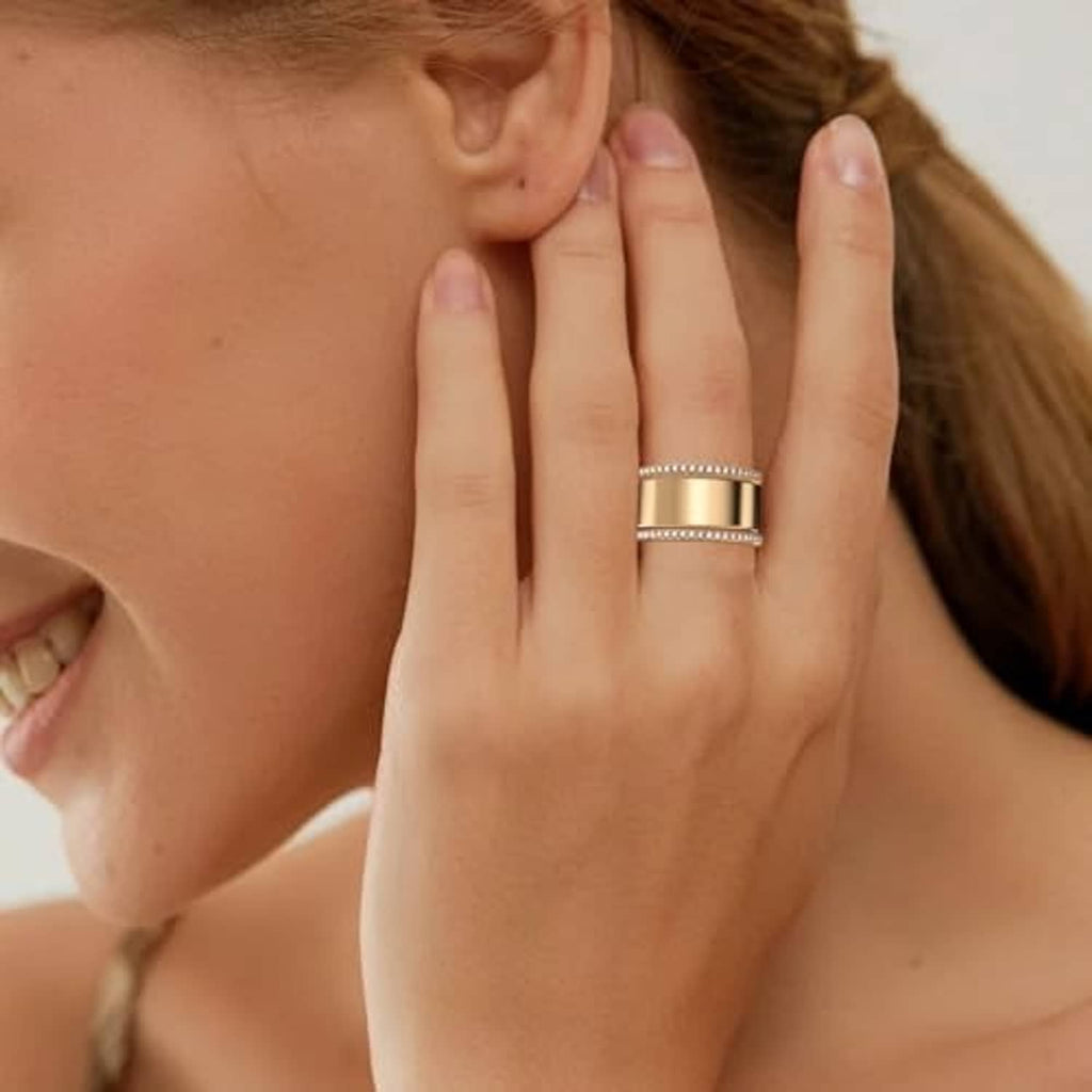 Gold stackable ring band set on a finger