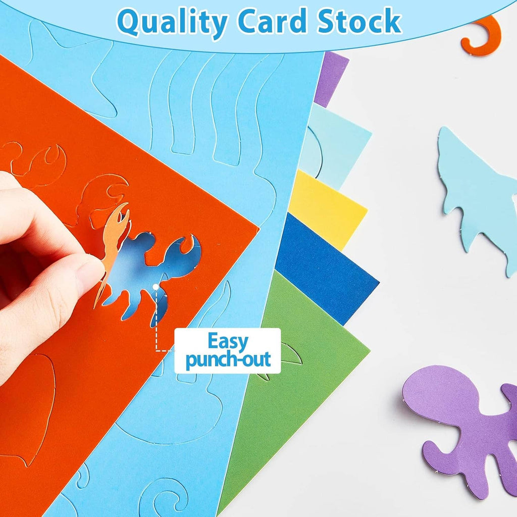 Ocean punch-out cutout shapes on colorful cardstock sheets, hand pressing a piece
