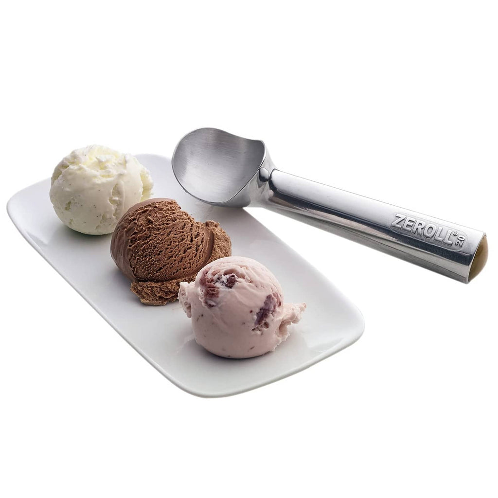 Zeroll ice cream scoop beside three ice cream balls on a white serving plate.