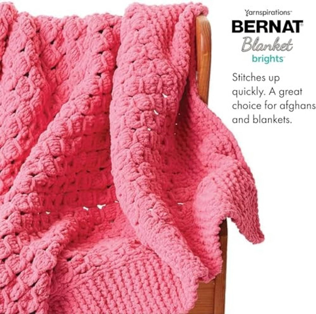 Soft pink chunky crochet blanket with textured loops and thick yarn drape