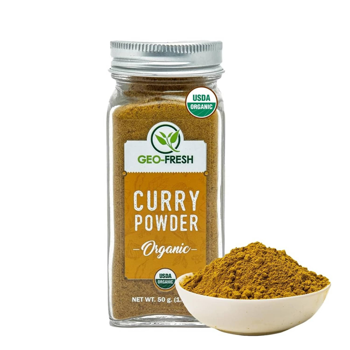 Organic curry powder jar with metal lid and a scoop of golden-yellow powder