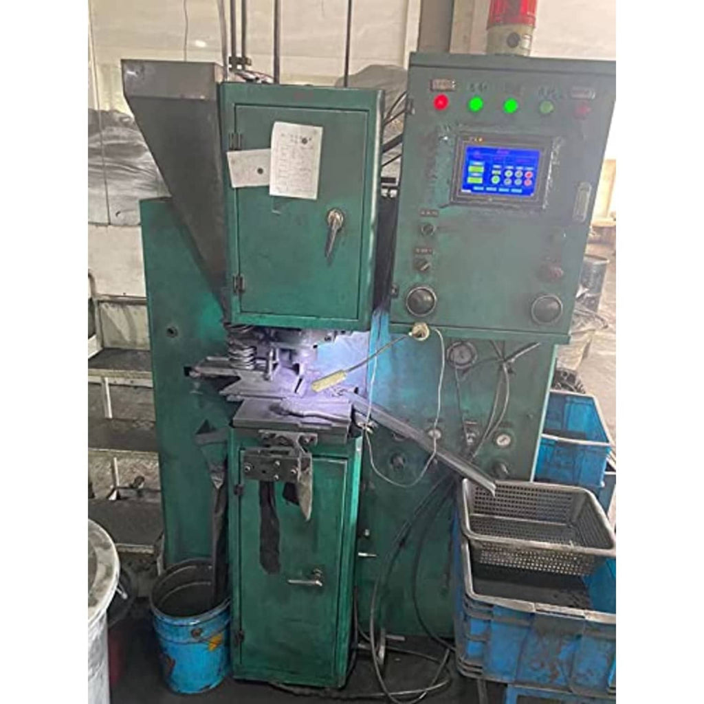 Green industrial machine with control panel and display in a workshop