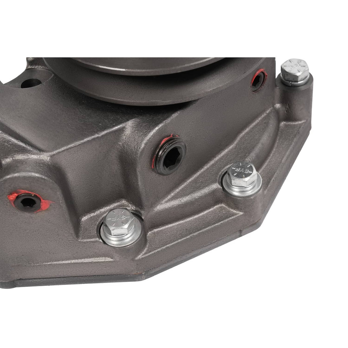 Water pump housing close-up with red gasket seals and silver mounting bolts