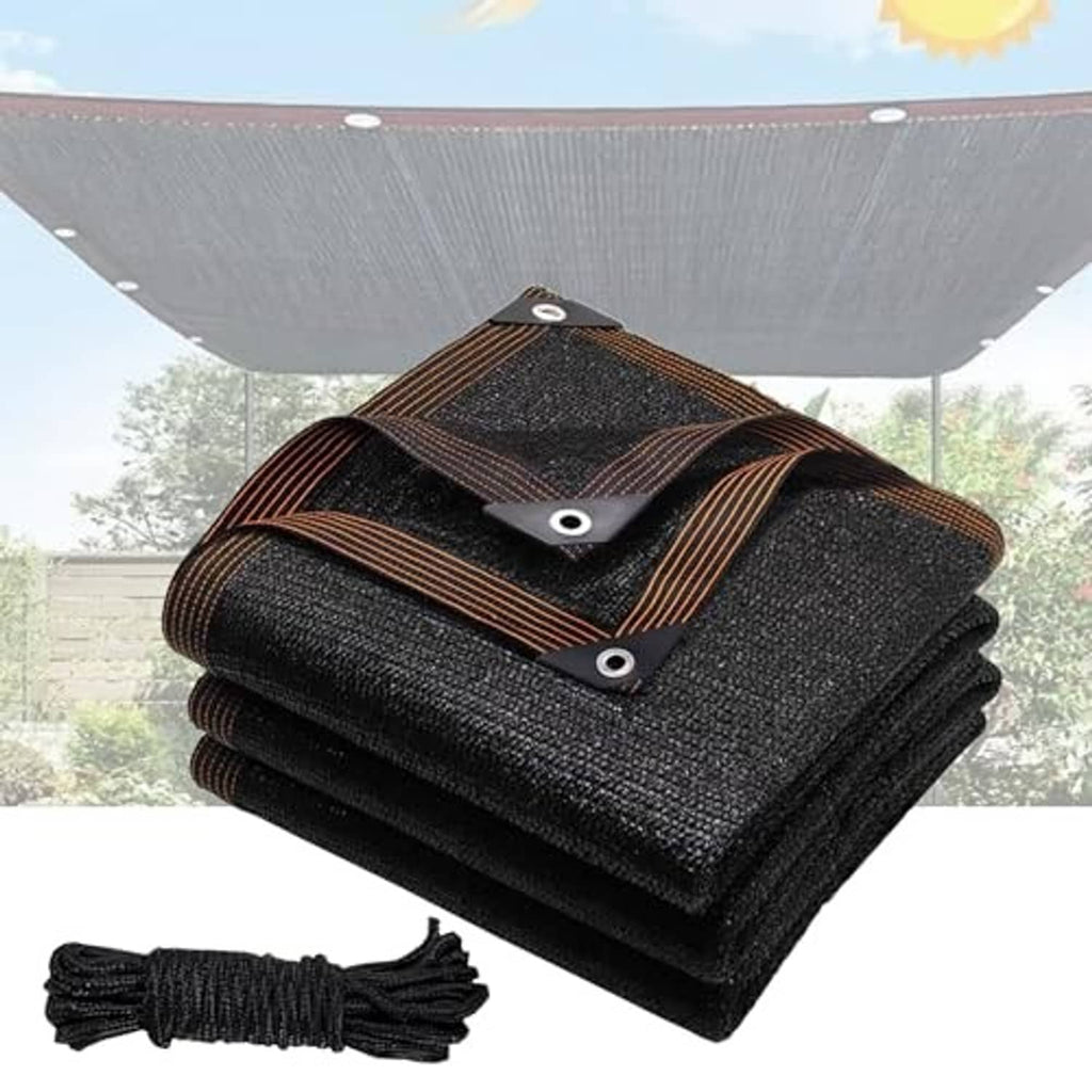 Folded black shade cloth sail mesh with corner grommets and brown stitched border straps