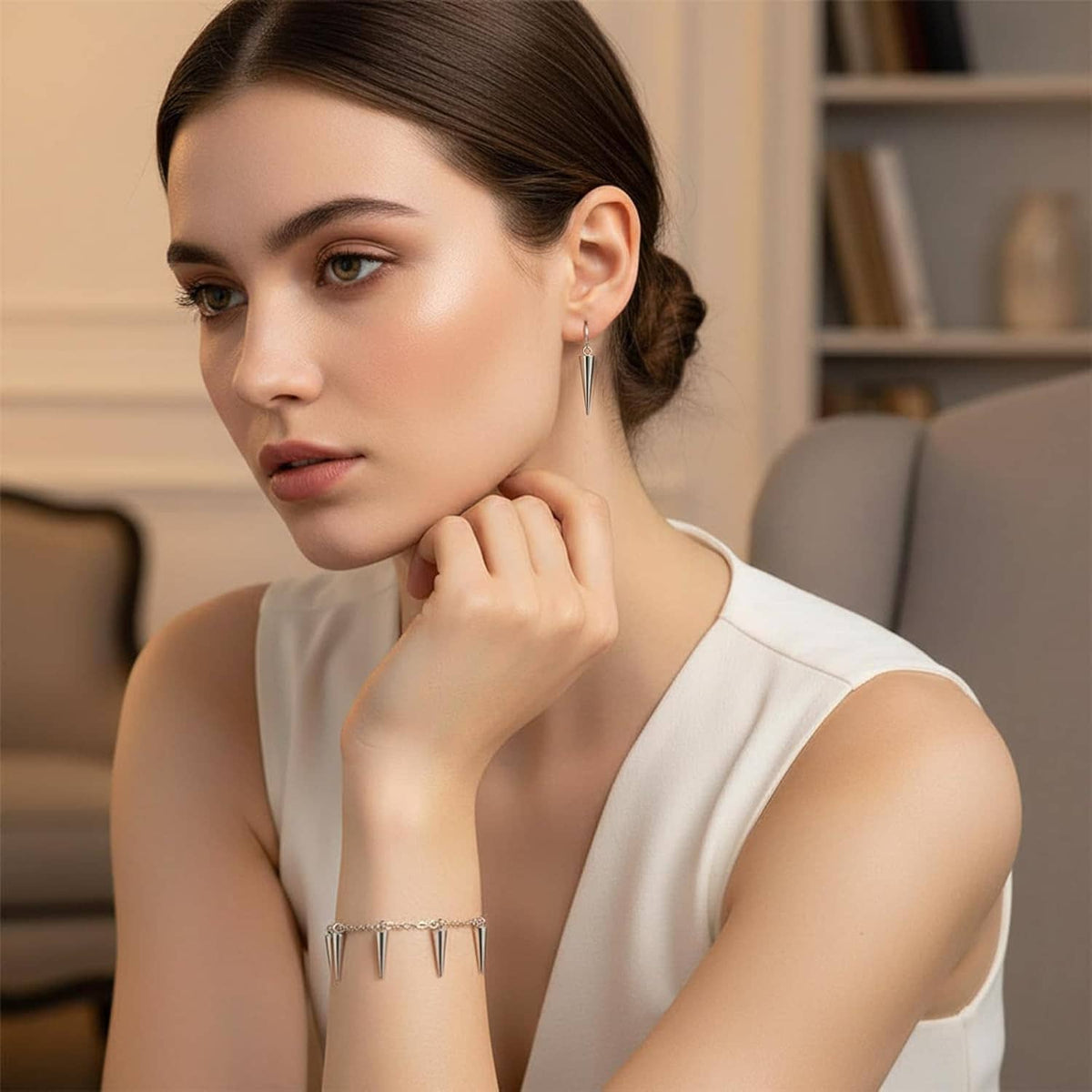 Silver spike cone earrings and spike bead bracelet on woman, conical charm details