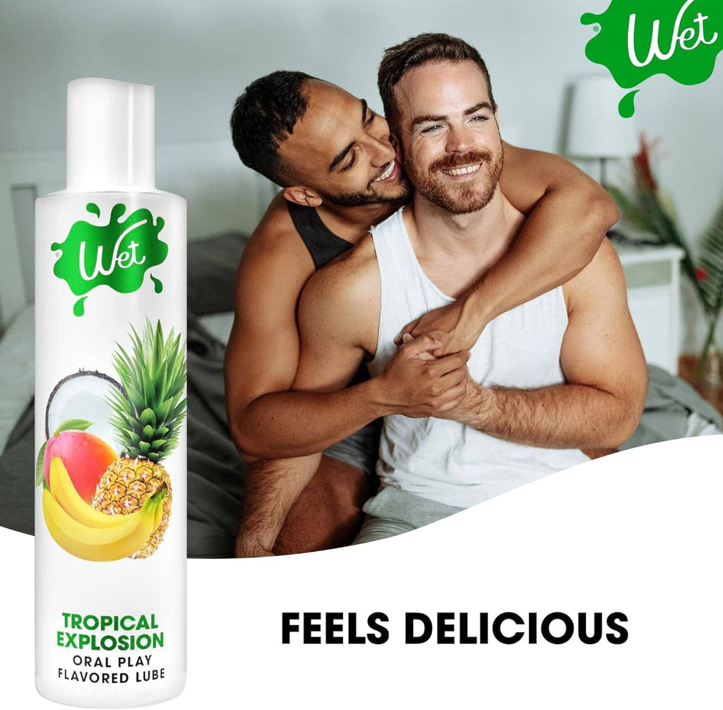Tropical Explosion lubricant bottle next to two men smiling together