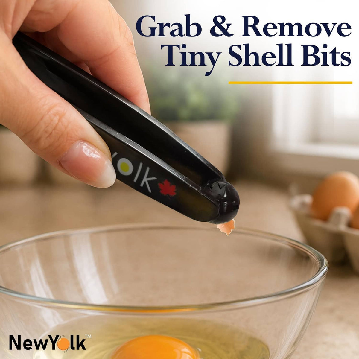 Black egg chalaza remover tool pinching tiny shell bits above a glass bowl