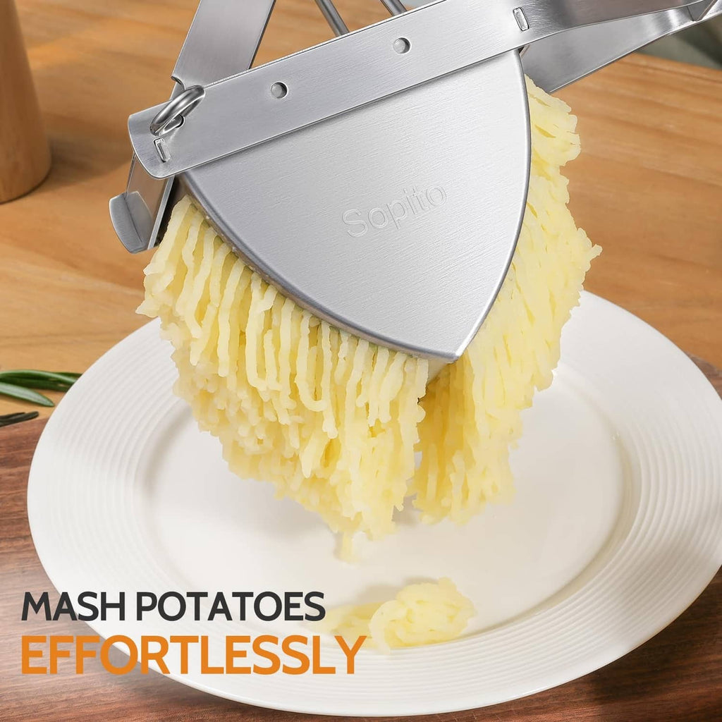 Stainless steel potato ricer pressing mashed potatoes from the perforated basket