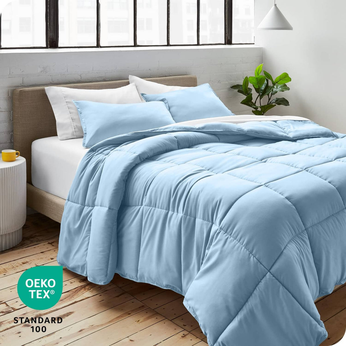 Light blue full comforter set with pillow shams, neatly bedded