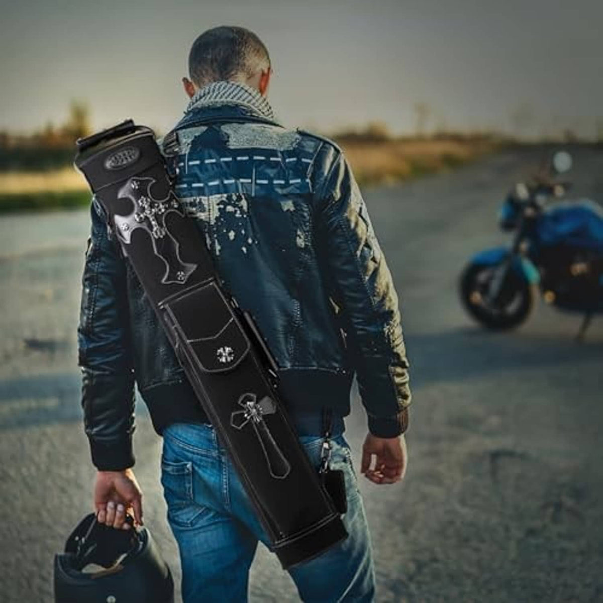 Black pool cue case with cross pattern worn on an adjustable shoulder strap outdoors