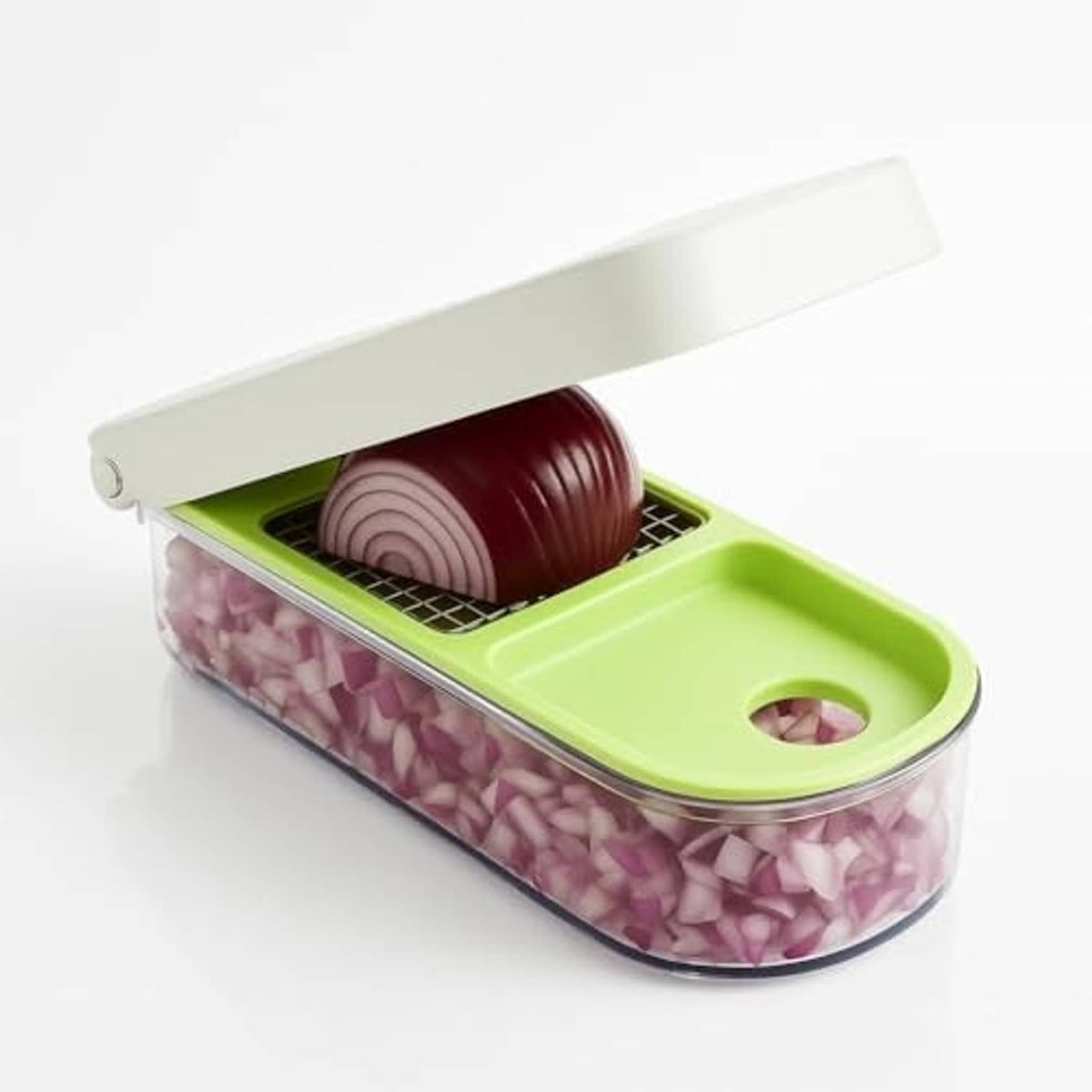 Green and clear vegetable chopper with purple diced onions inside and lid closed
