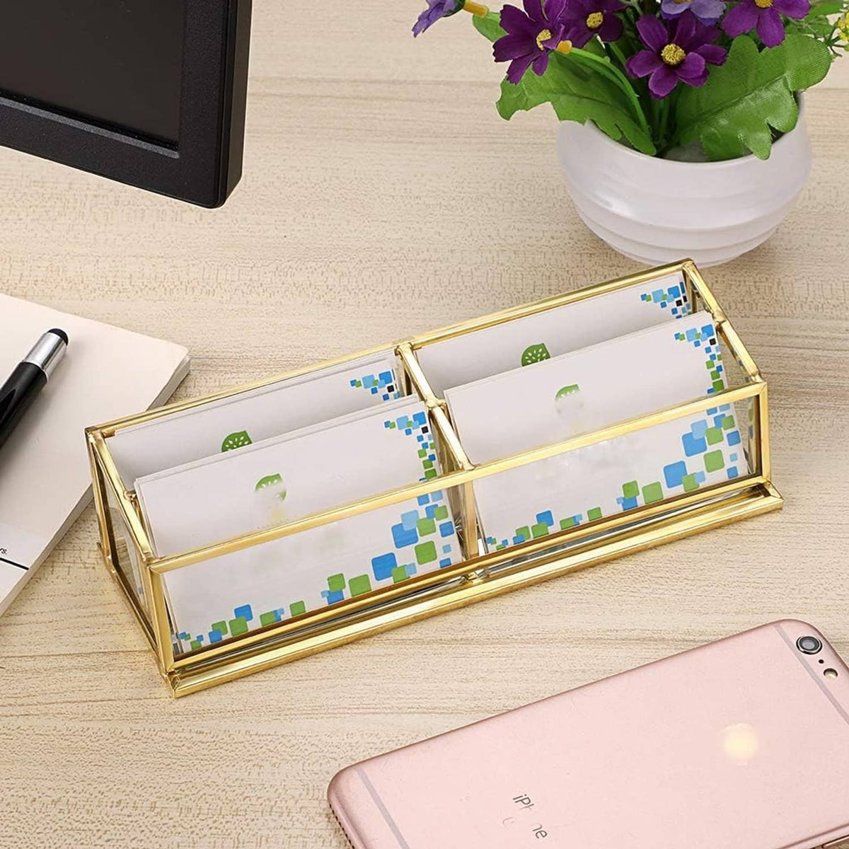 Gold 4-slot business card holder with clear glass and colorful card inserts visible