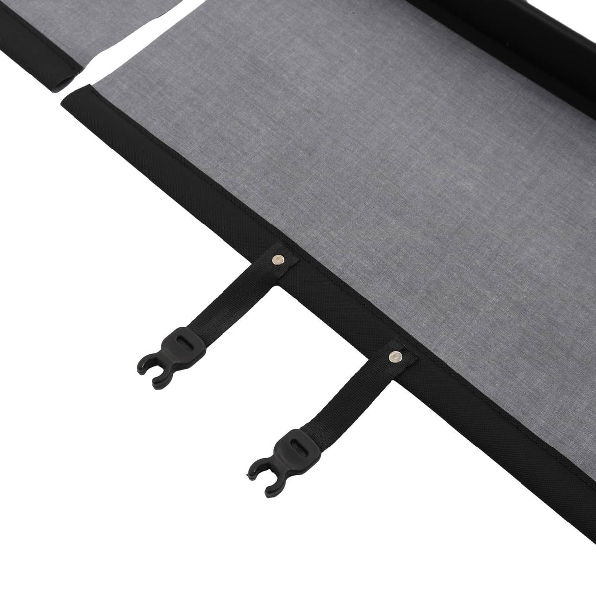 Rear trunk security shade cargo cover detail of gray fabric secured by black snap tabs