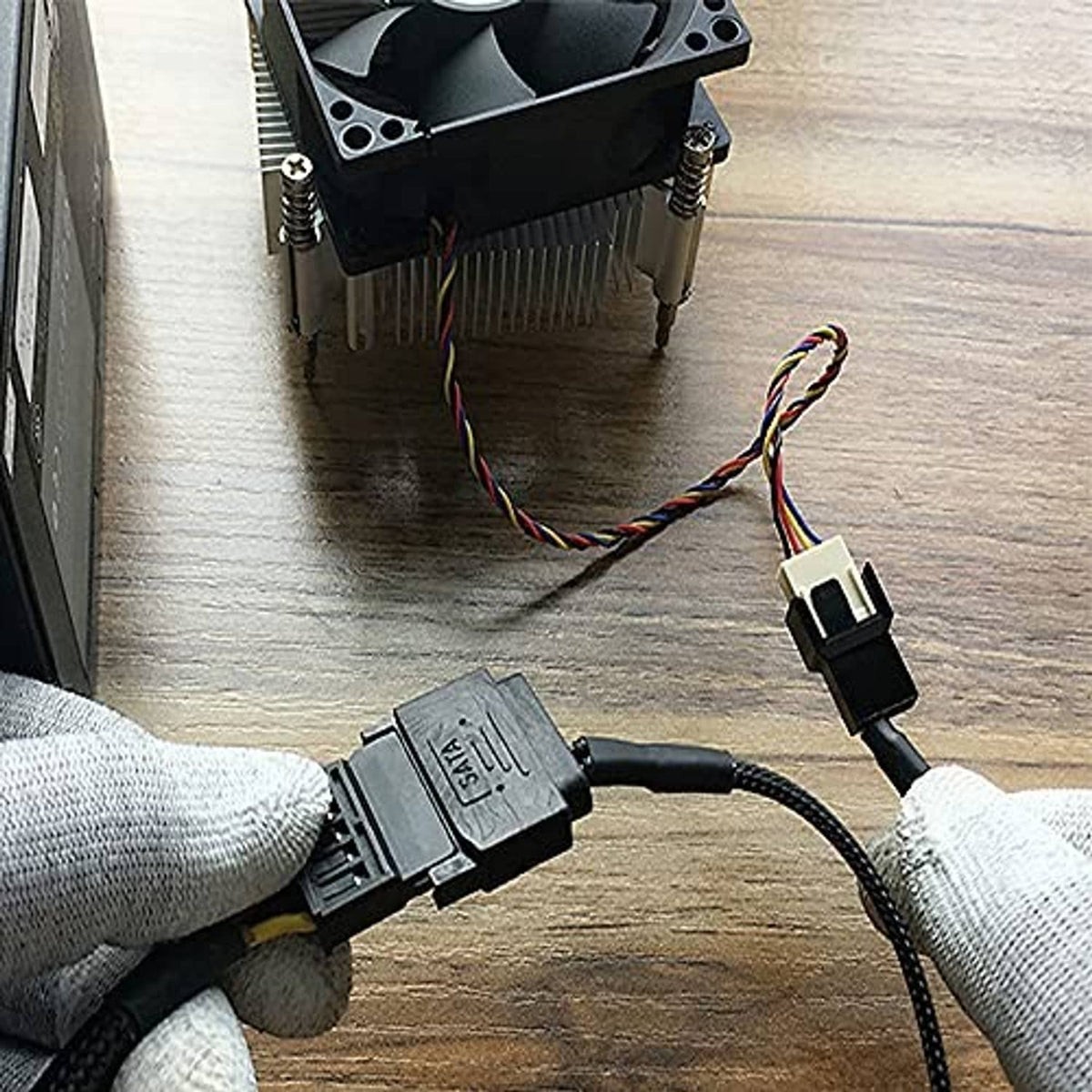 SATA power splitter Y cable with sleeved leads and 15-pin male plug connected to device
