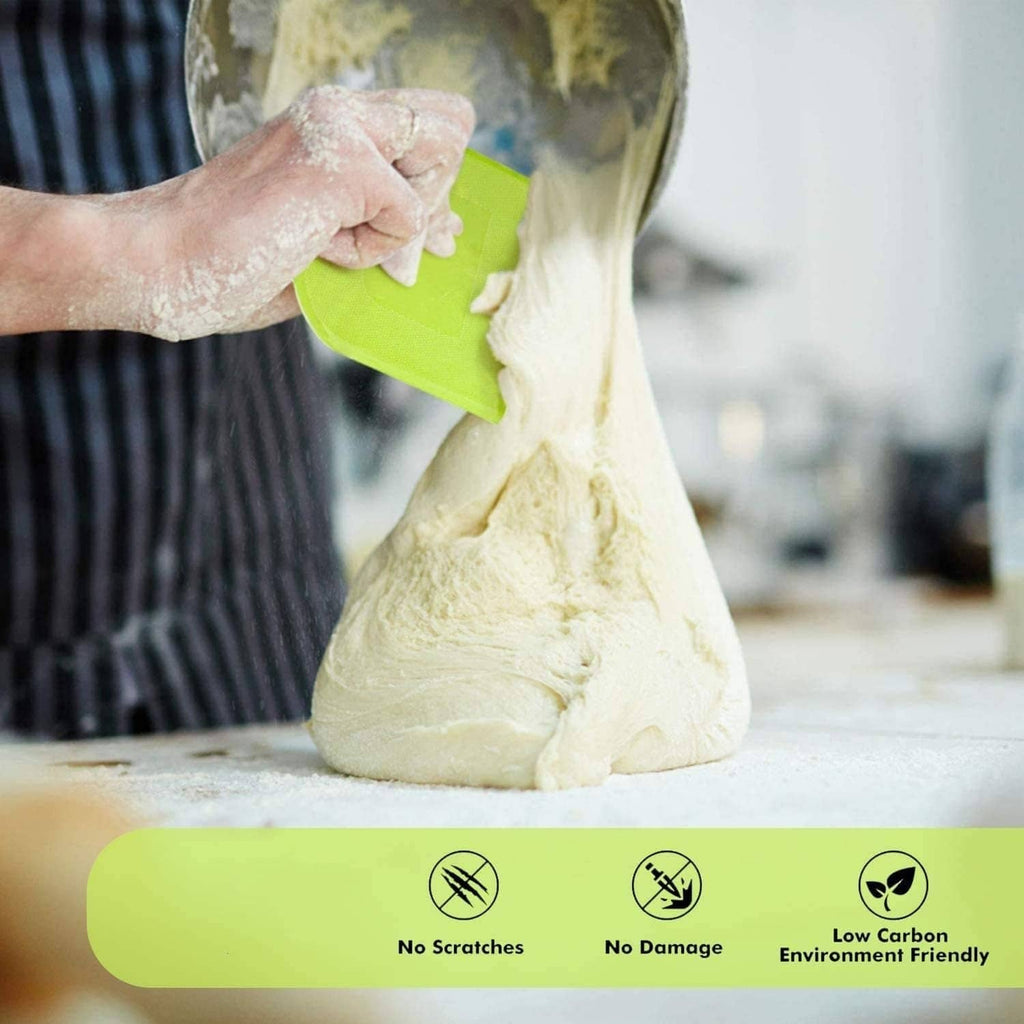Green silicone dough scraper bench, used to lift dough from a countertop bowl