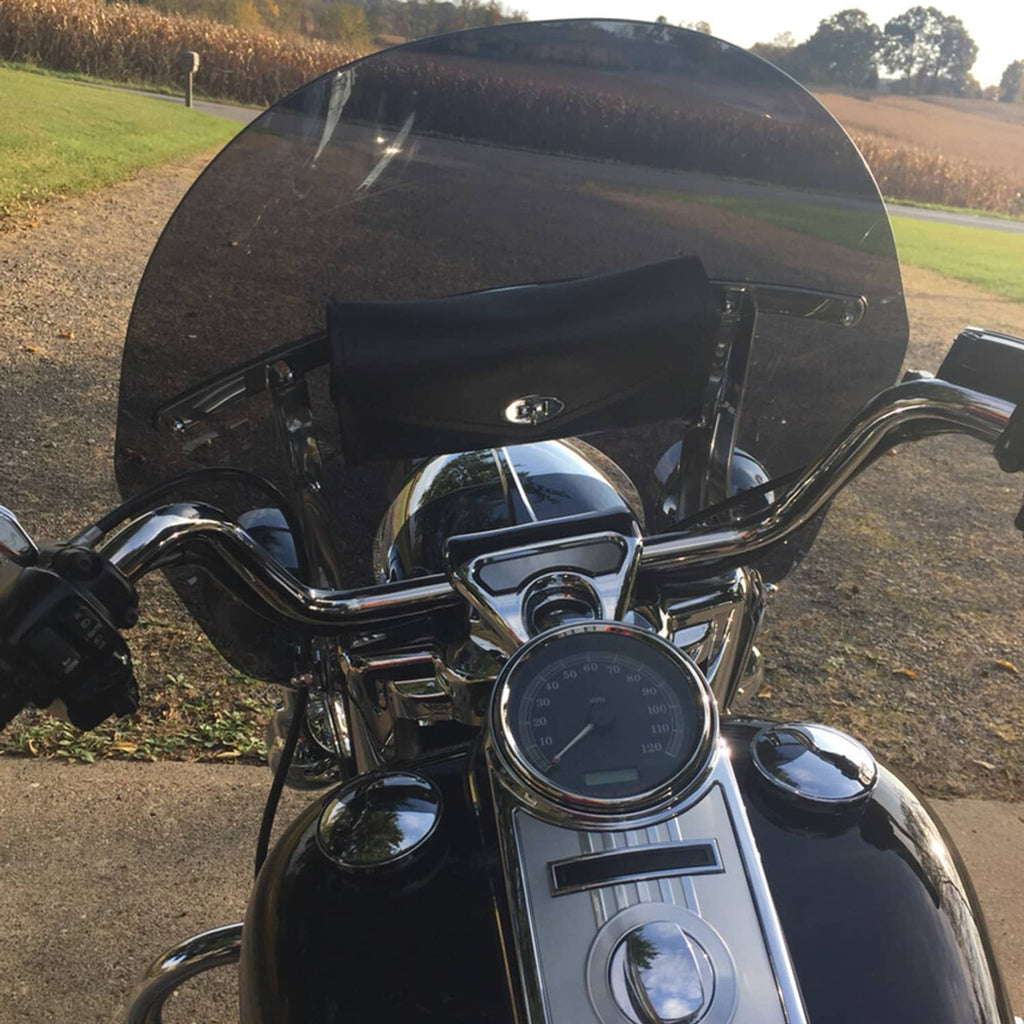 Mounted dark tinted motorcycle windshield on handlebars with chrome trim