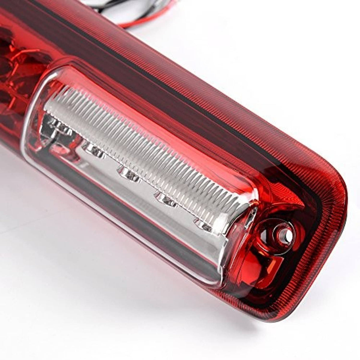 Close-up of clear-lens third brake light end with red bezel and mounting hole