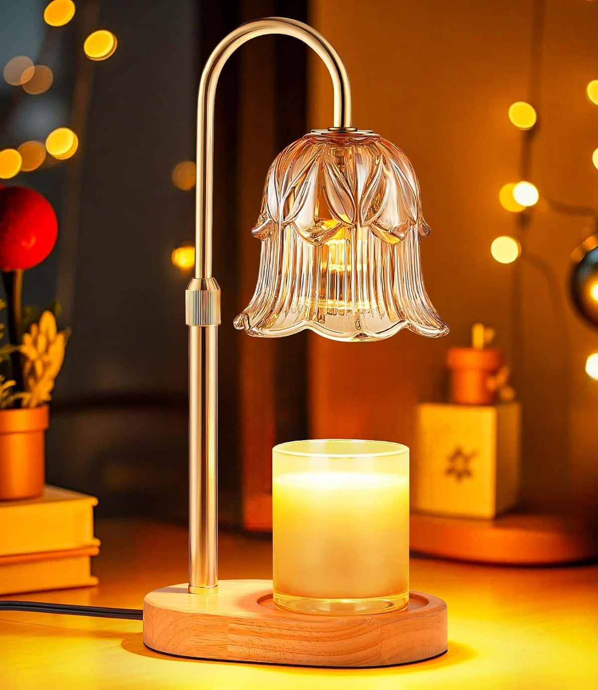 Electric candle warmer lamp with amber glass bell shade and glowing candle