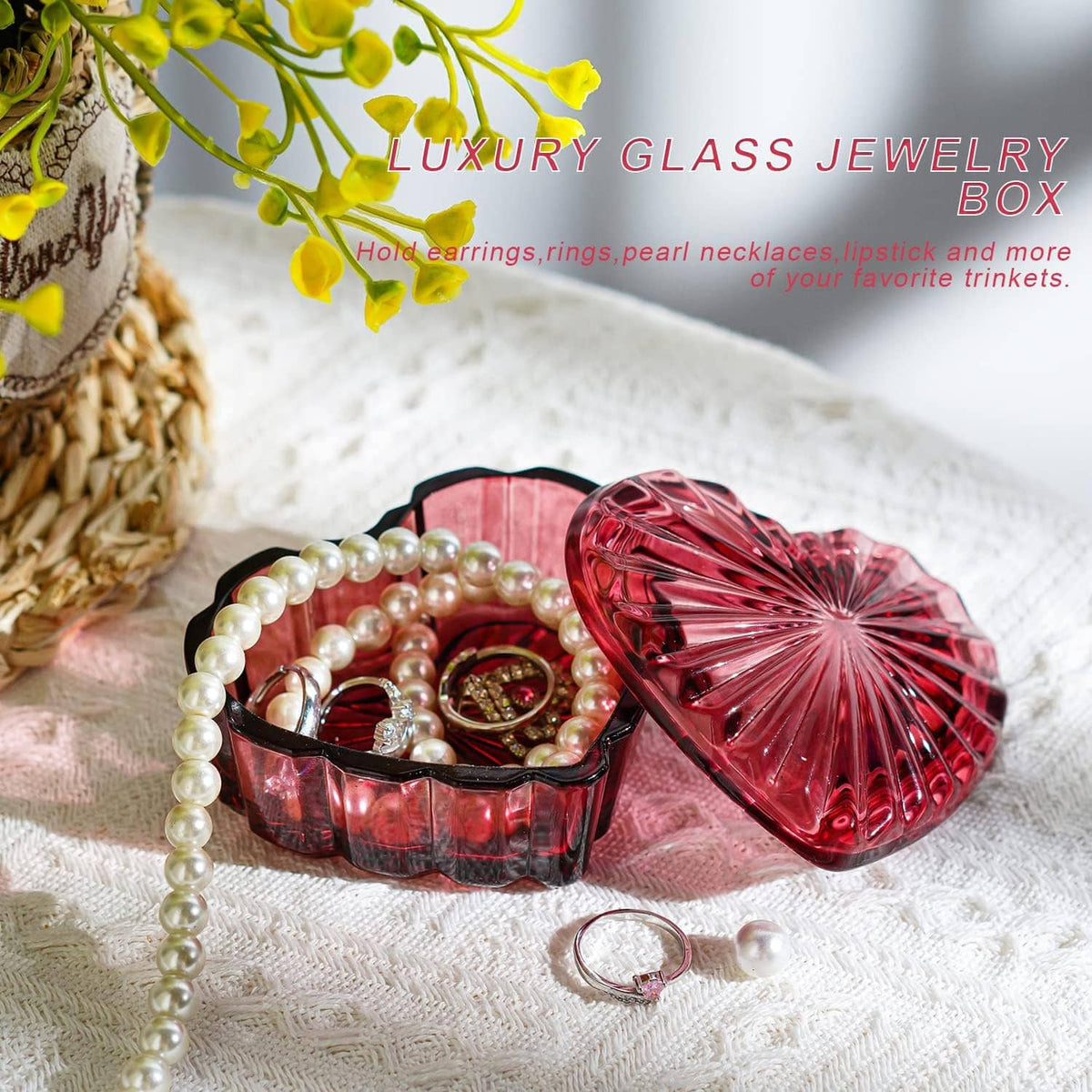 Red heart-shaped crystal jewelry box with lid, holding pearl necklace