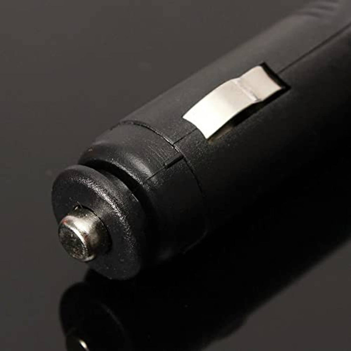 12V power plug with metal tip and black cable connector close-up