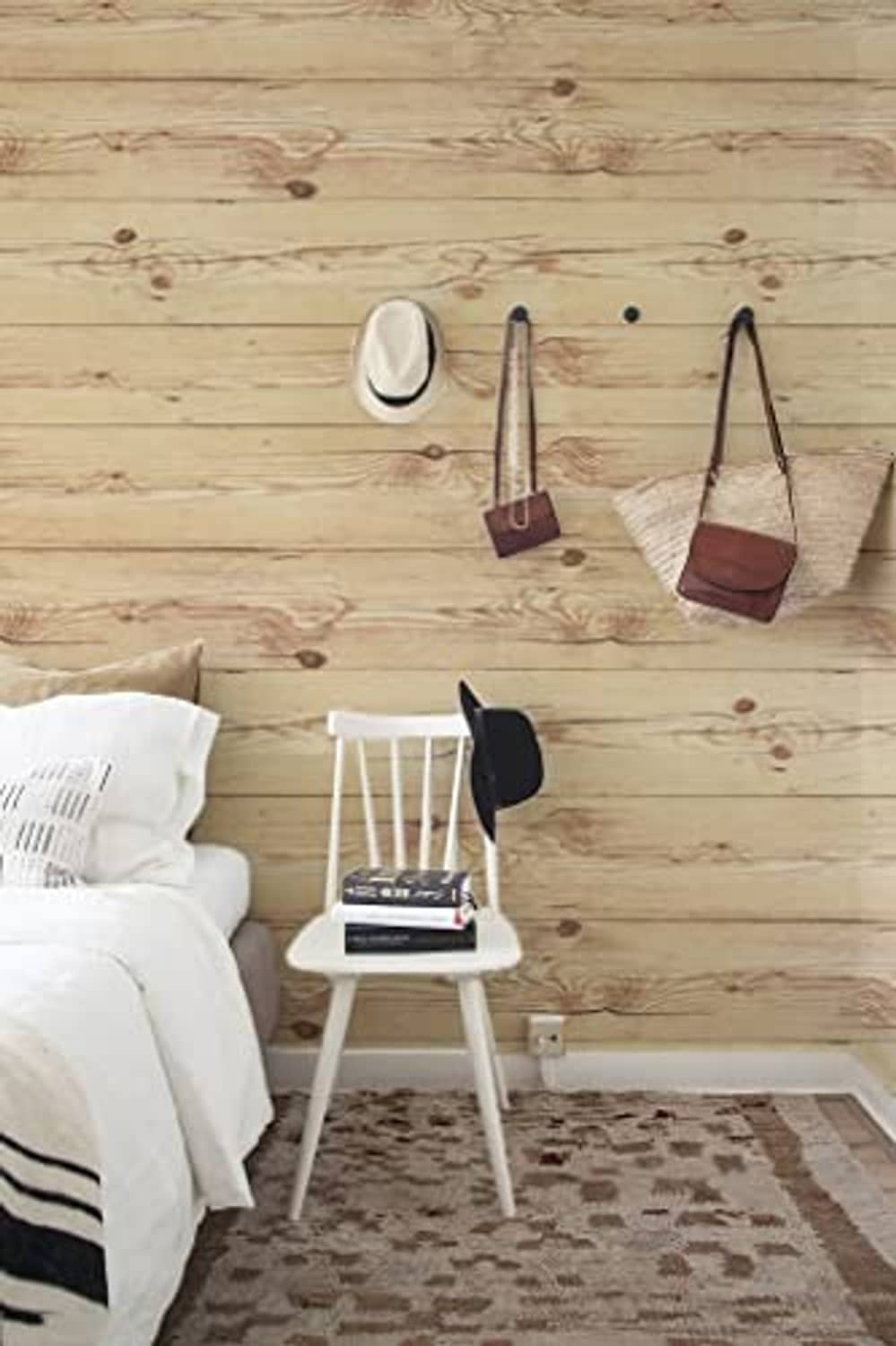 Light tan wood plank wall covering with visible knots and straight seam lines