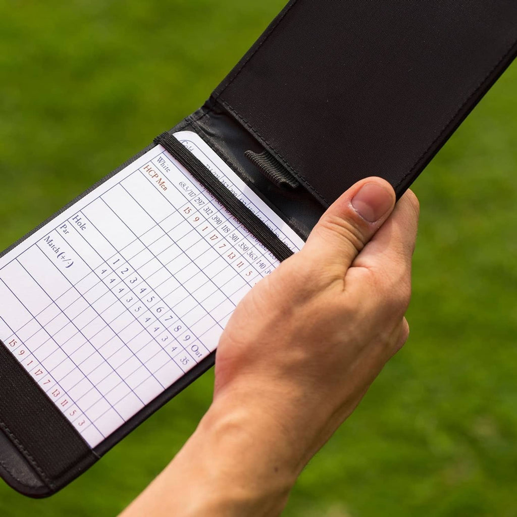Black leather golf scorecard holder open, showing lined scorecard pages